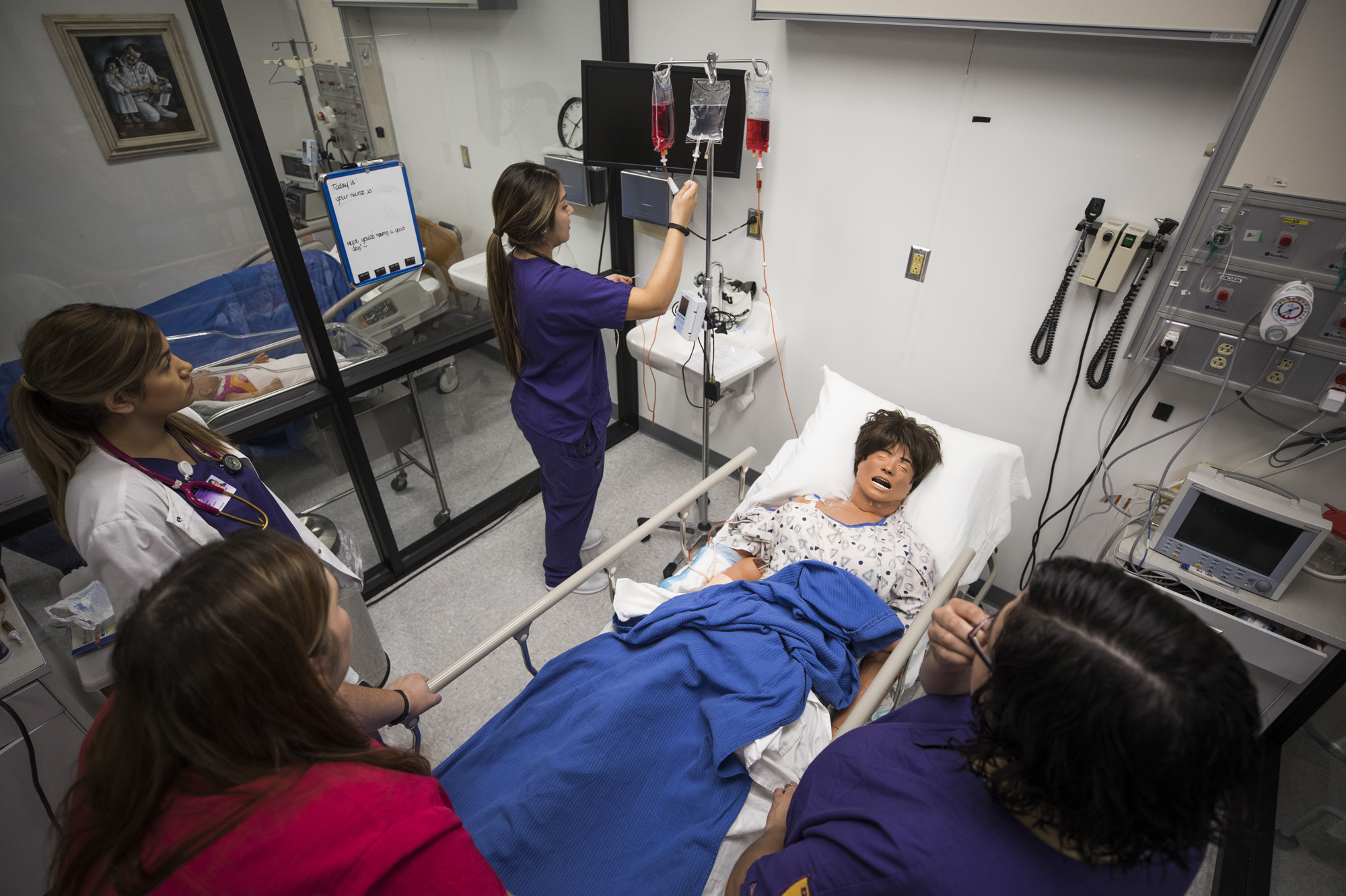 Student nurses in the lab under the supervision of instructors