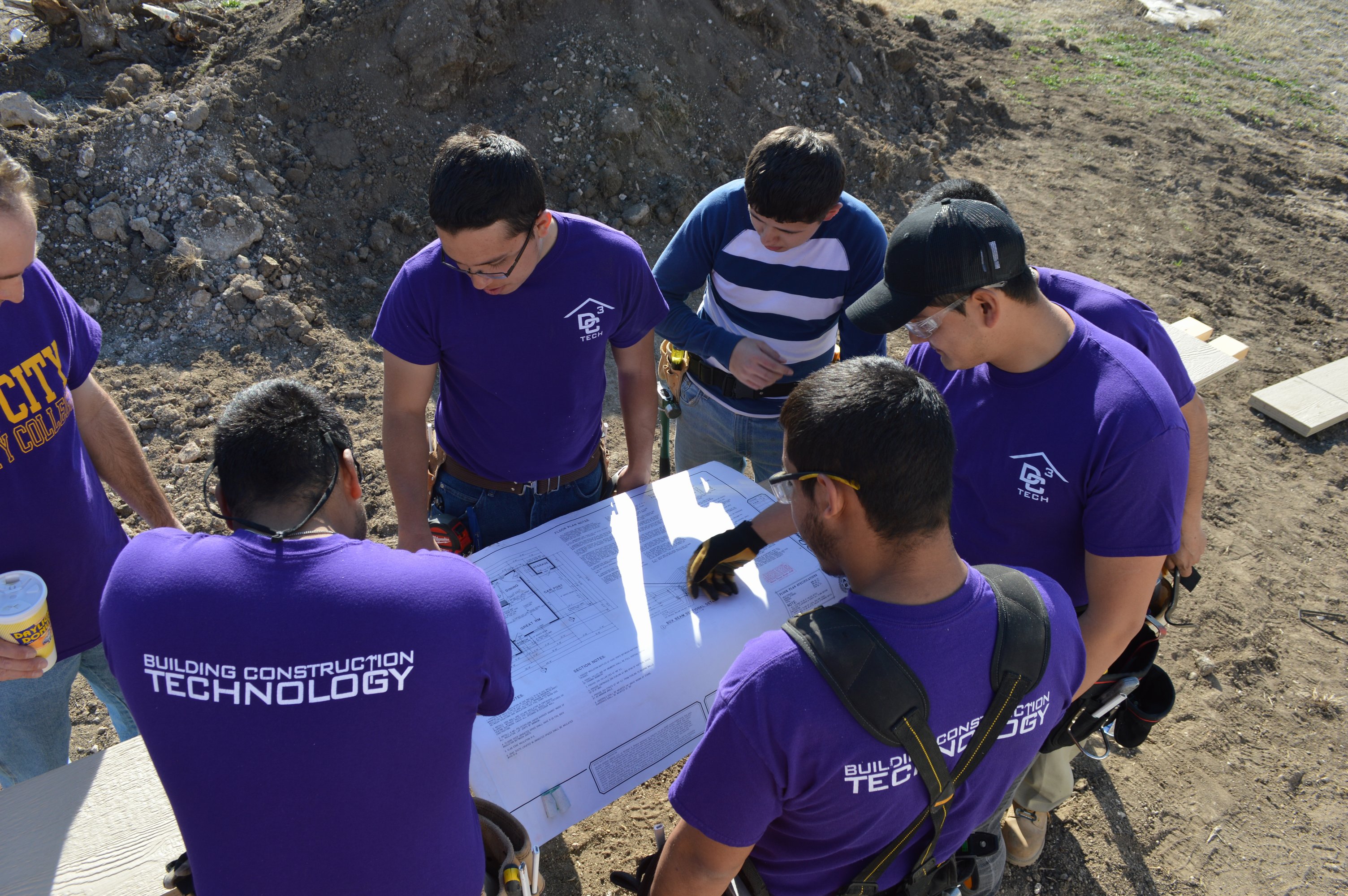 Building construction trades students reviewing blueprints