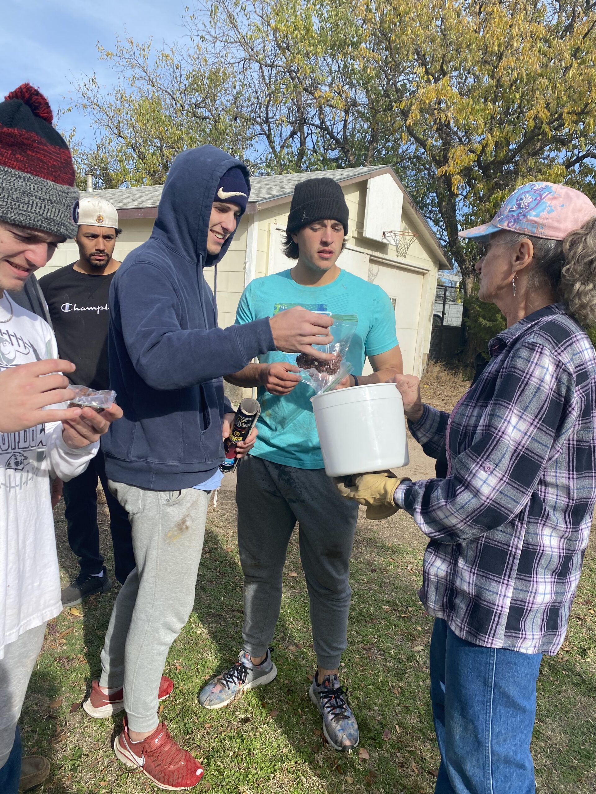 Above, members of the baseball team enjoy no-bake cookies provided by one of the home owners during the Fall Cleanup Day. Pictured (left to right) are Camden Thrailkill, a redshirt freshman from Denton, Texas; Diego Dominguez, a redshirt sophomore from Vaughan, Ontario, Canada; Jacob Loflin, a sophomore from Edmond, Okla.; and Blake Anderson a sophomore from Royse City, Texas. [Photo by Annalynn Kirkhart]