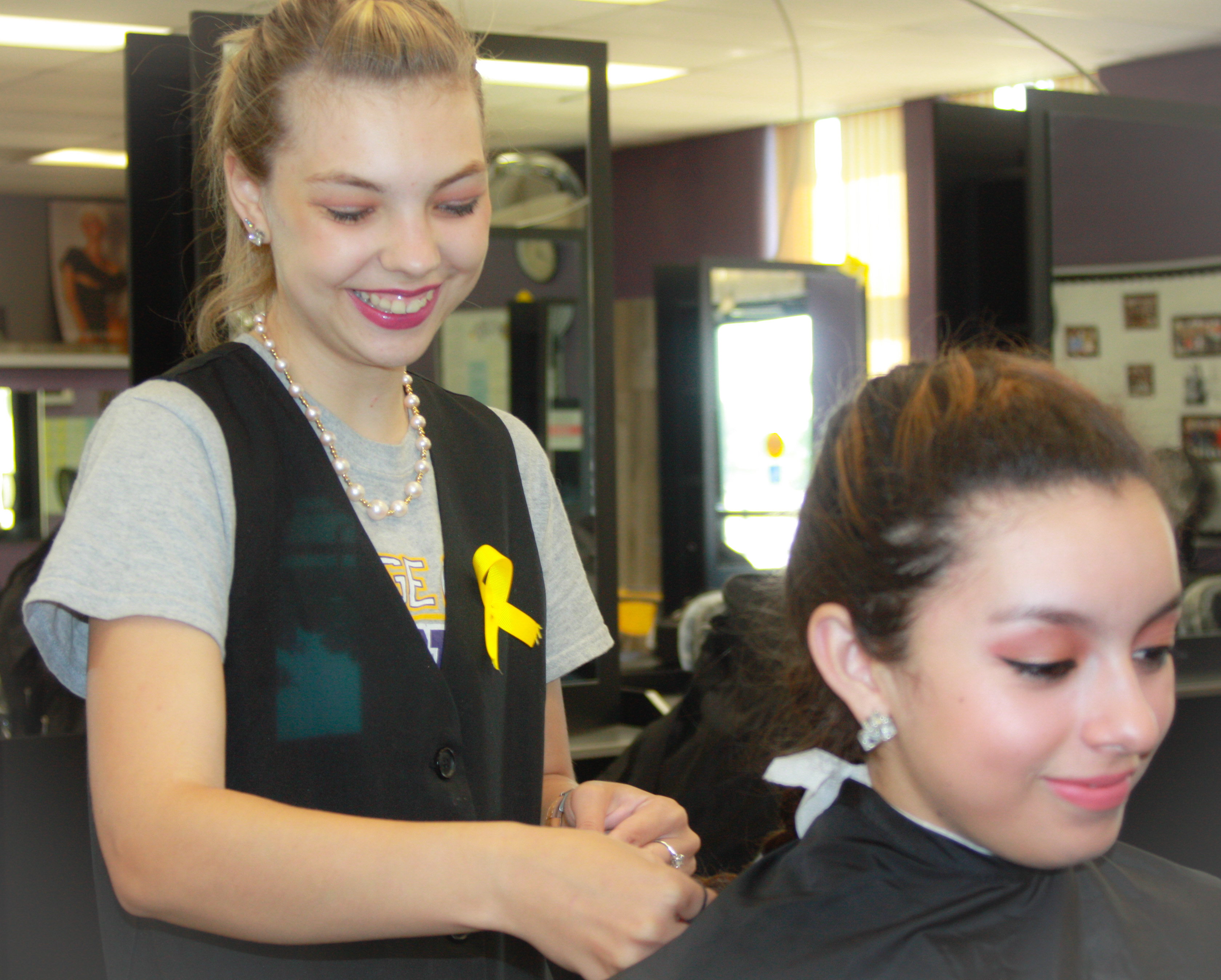 Sierra McCain works on a client in the DC3 Cosmetology salon.