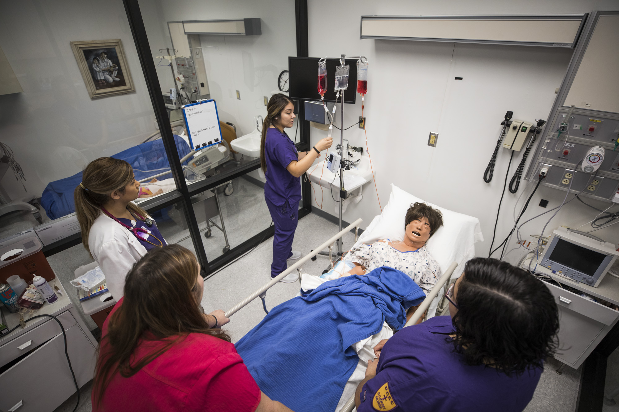 Nursing students practicing in the lab