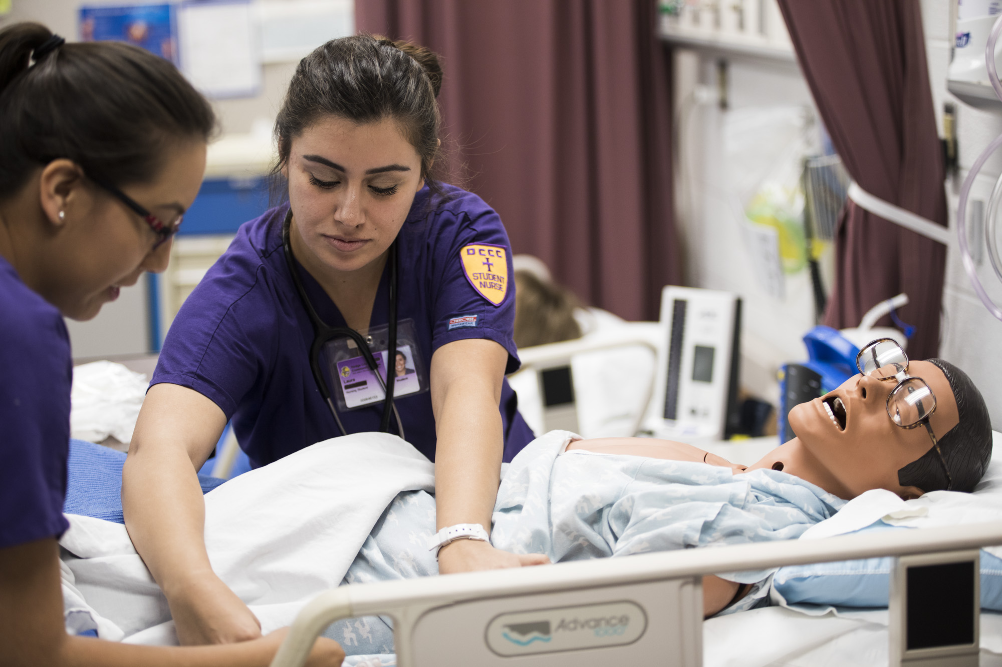 Nursing students practicing in the lab