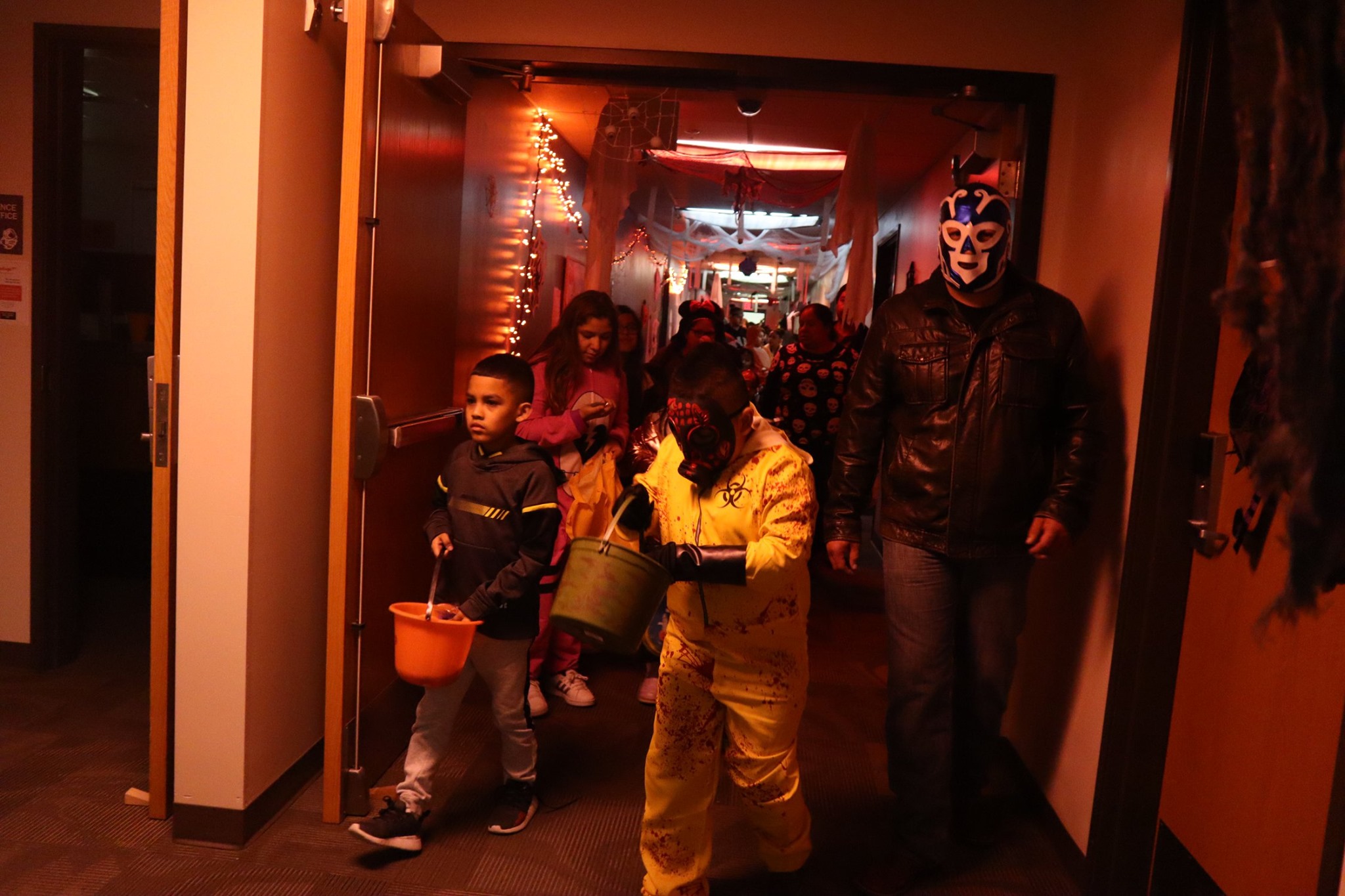 Children walking through Jackson hall during the 2019 community trick or treat