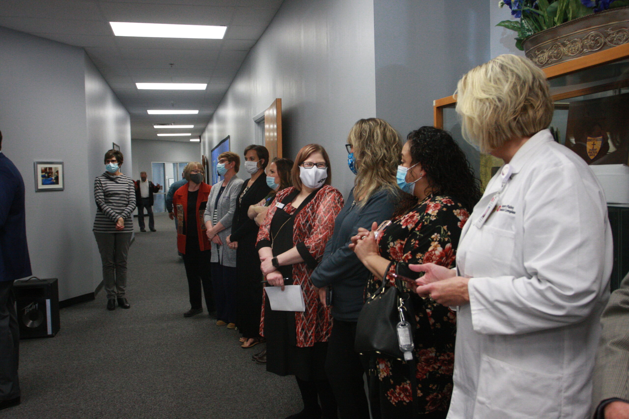 The DC3 Nursing faculty line the hall during the Floris Jean Hampton Nurse Education Center dedication